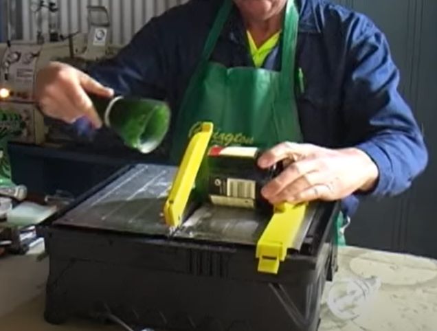 Cutting glass bottles on a tile saw.
